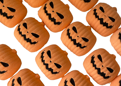 Pattern of small pumpkins with jack-o'-lantern faces on a bath bomb white background